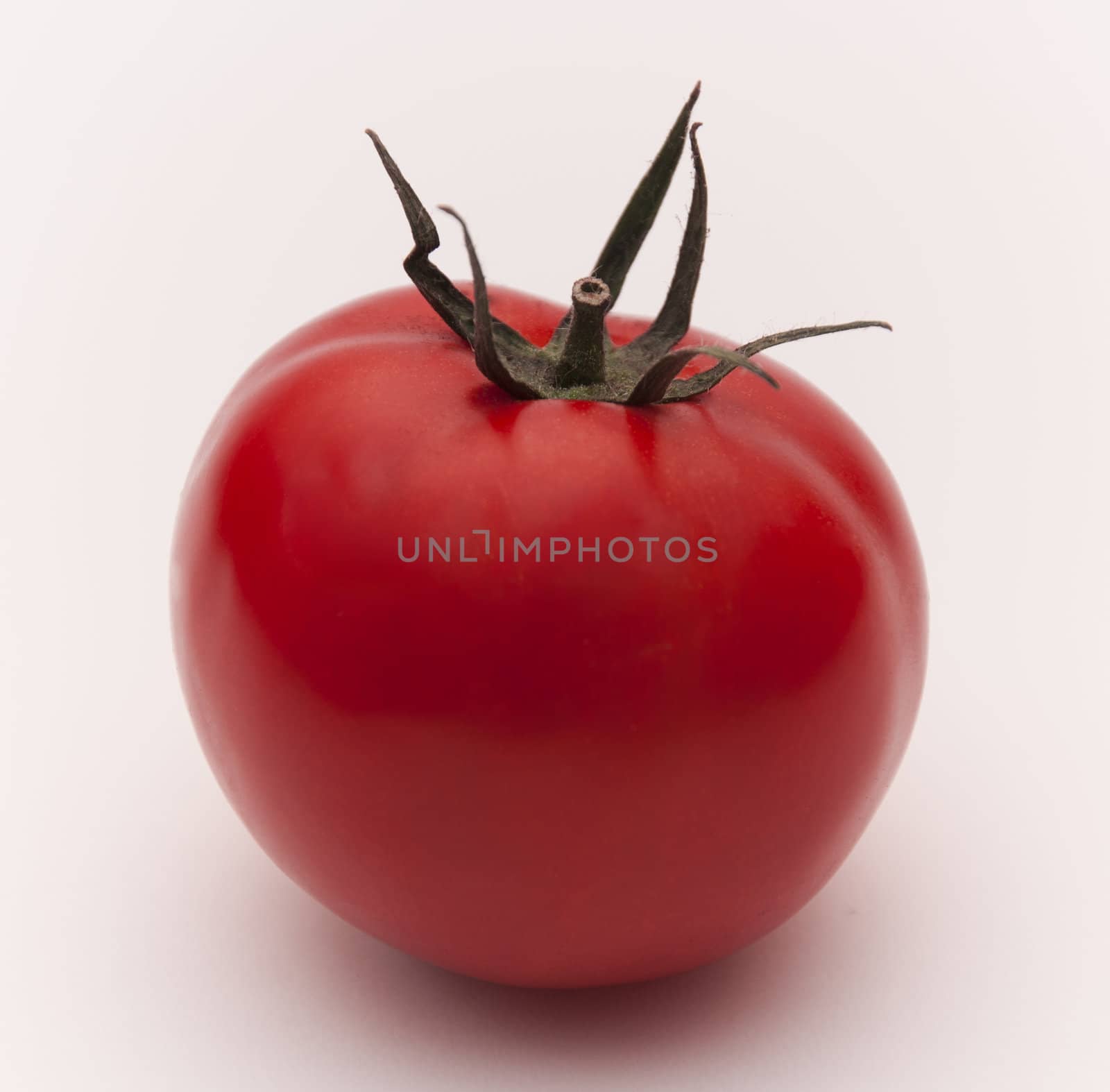 Red ripe tomato isolated on the white