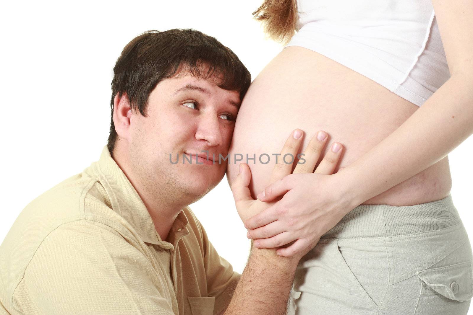 Beautiful moment between expecting parents: man embracing belly of his wife 