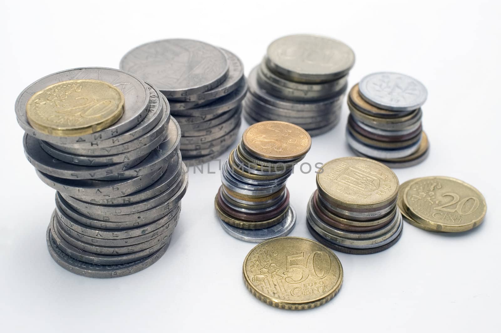 Stacks of coins, isolated on white background.