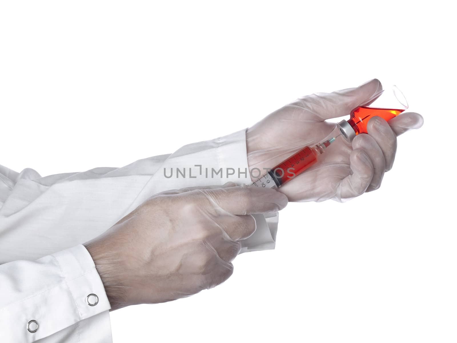A doctor is taking a dose of a red medicine out of the vial.