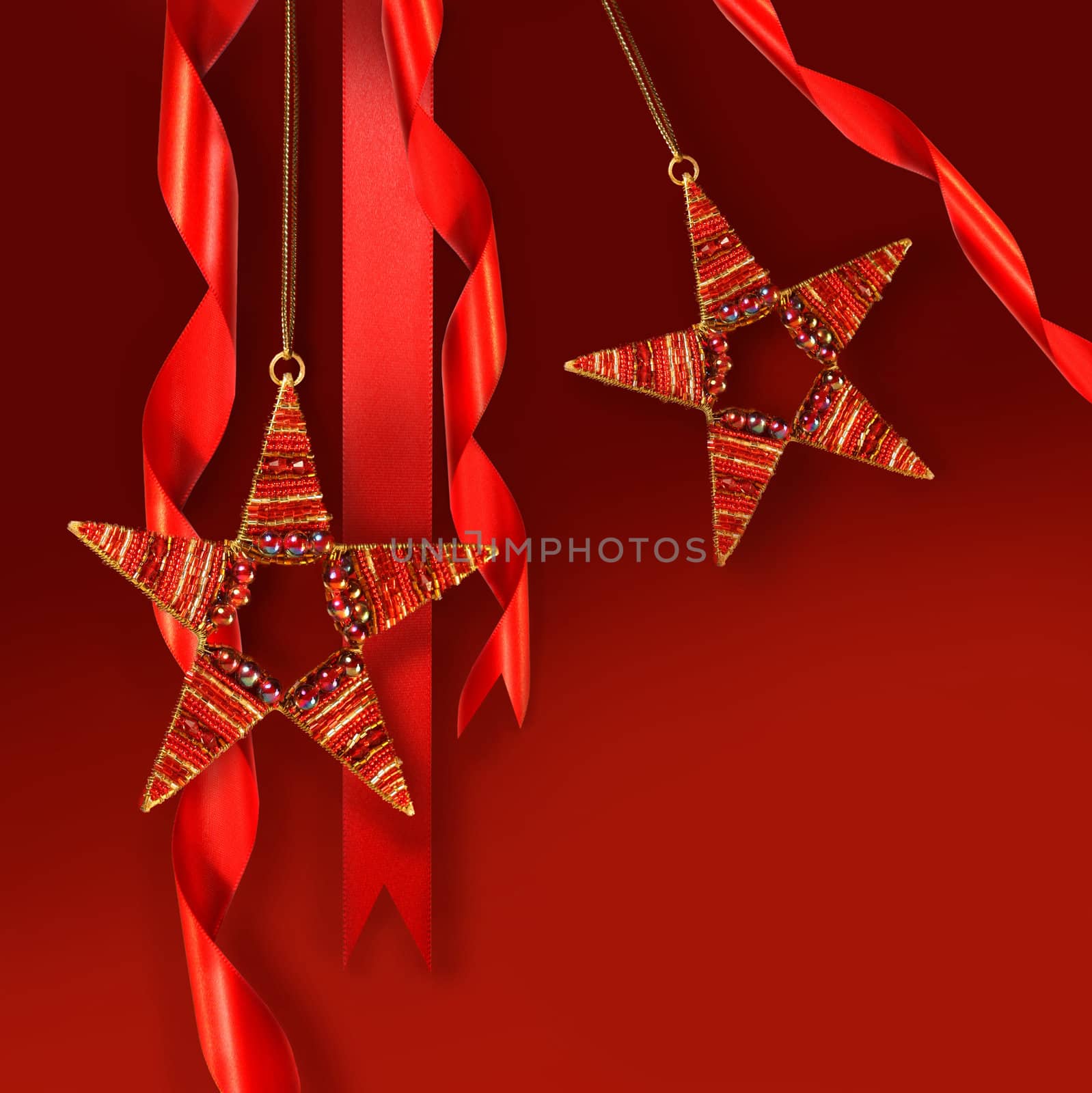 Christmas star ornaments against red holiday background
