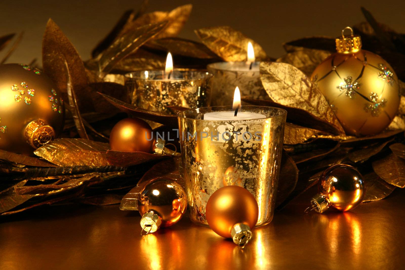 Candles light with a sparkling gold theme