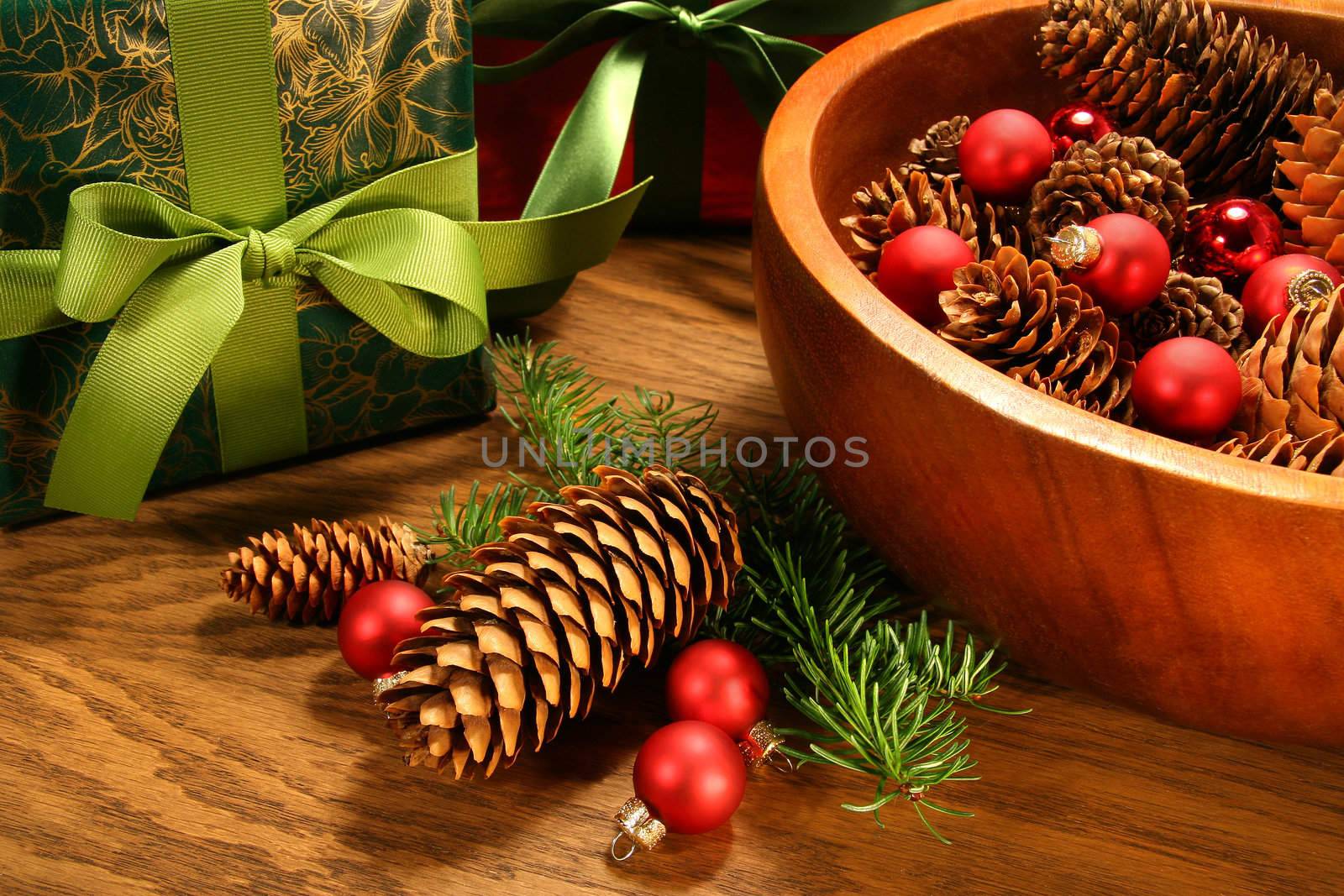 Pine cones , christmas balls and gifts on oak table