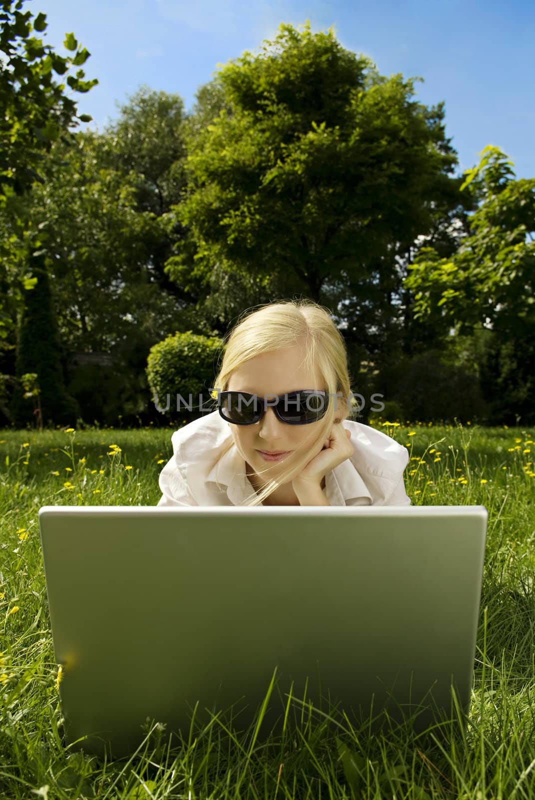 young woman working outside on computer 