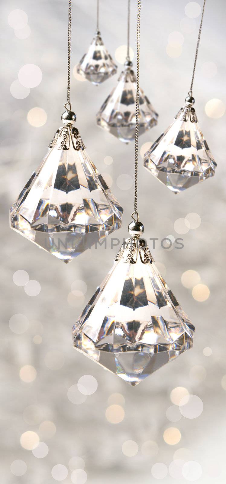 Crystal christmas ornaments against festive silver background