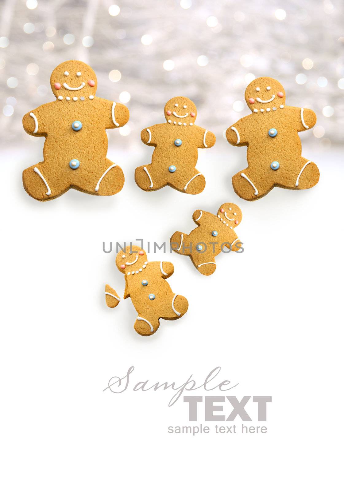Gingerbread men cookies against sparkly white  by Sandralise