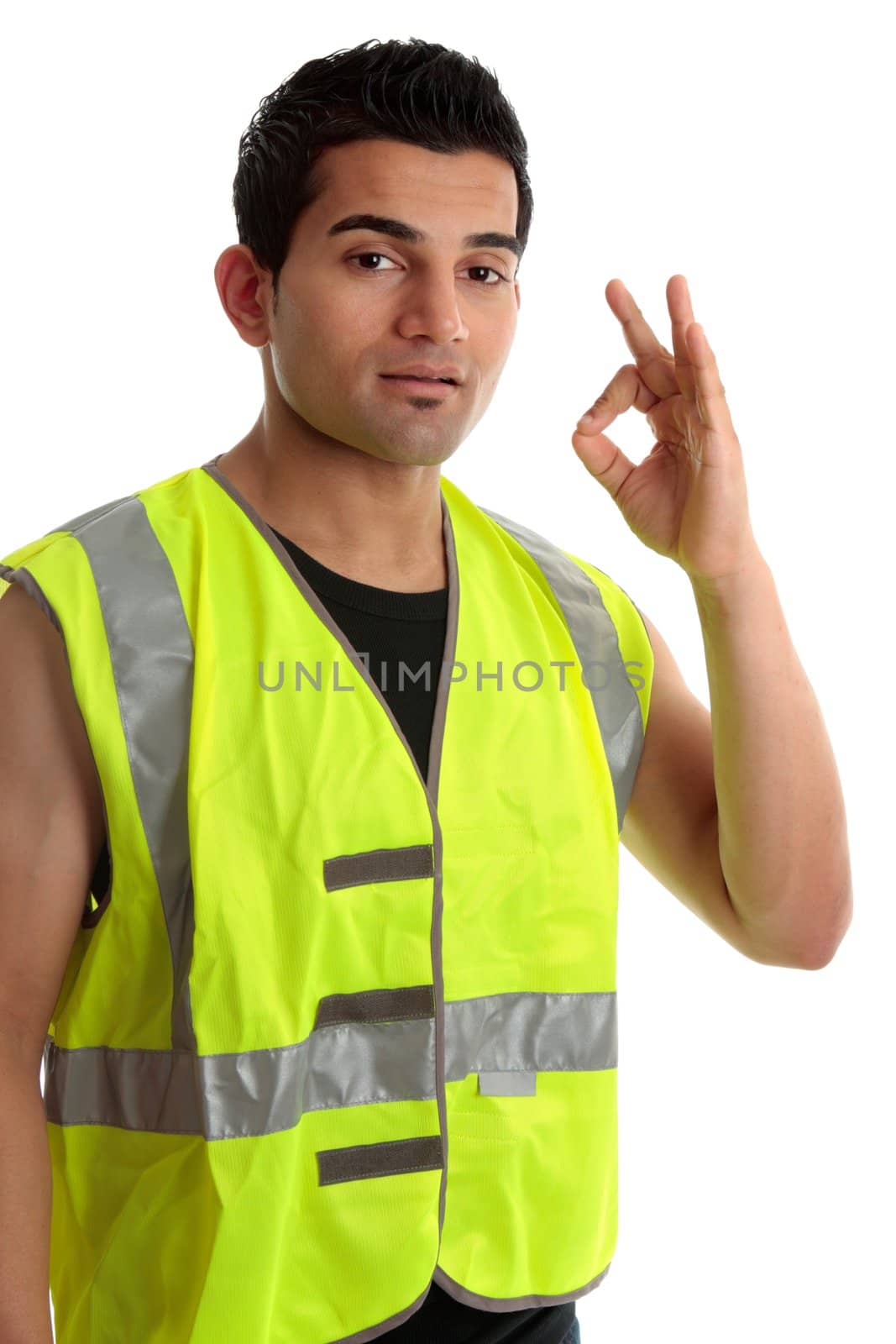 Ethnic mixed race, blue collar man such as a builder, tradesman, labourer, handyman gestures a positive a-ok approval hand sign gesture.  White background.