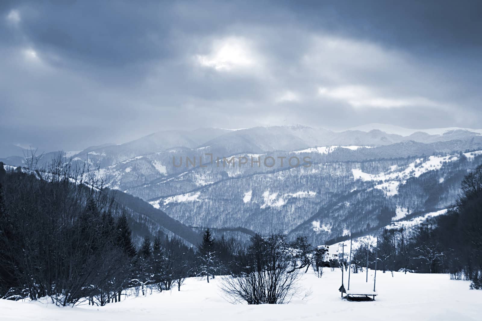 winter landscape with a mountains and a moody sky