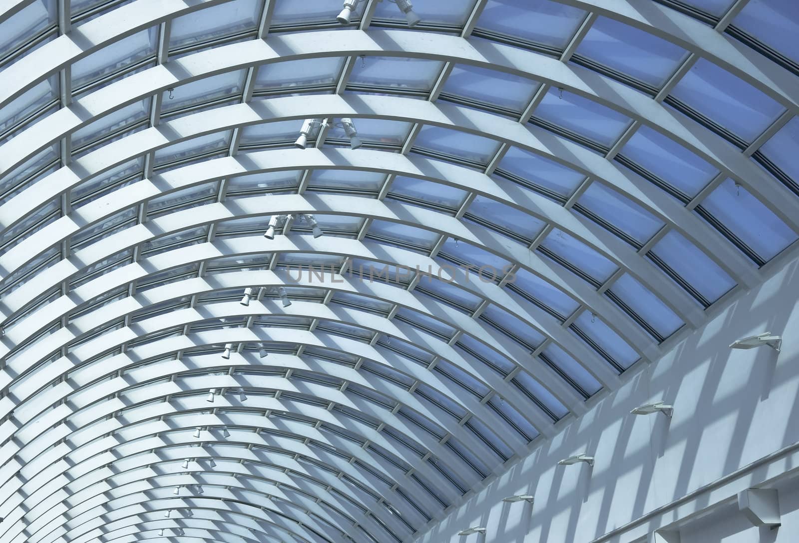 Detail of public interiors. Ceiling light atrium through the translucent roof. Clear shadows and light.