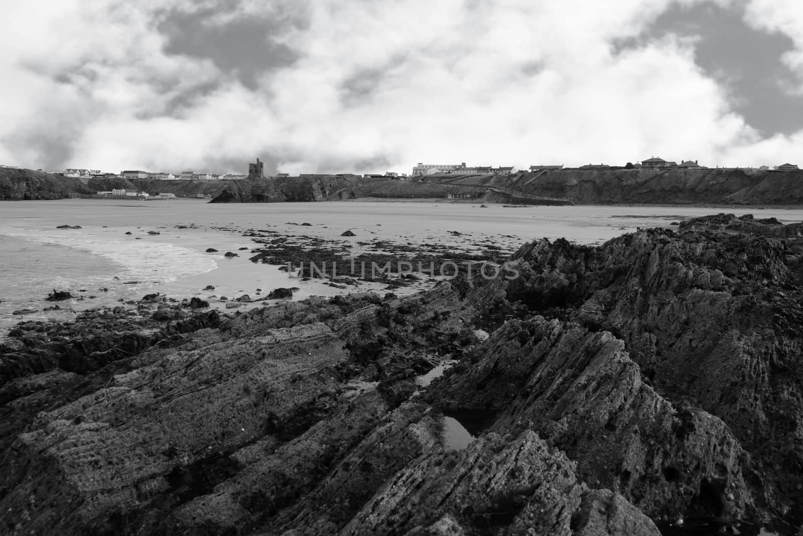 a rocky beach on a warm day with a calm sea an ideal place to have a walk in ireland