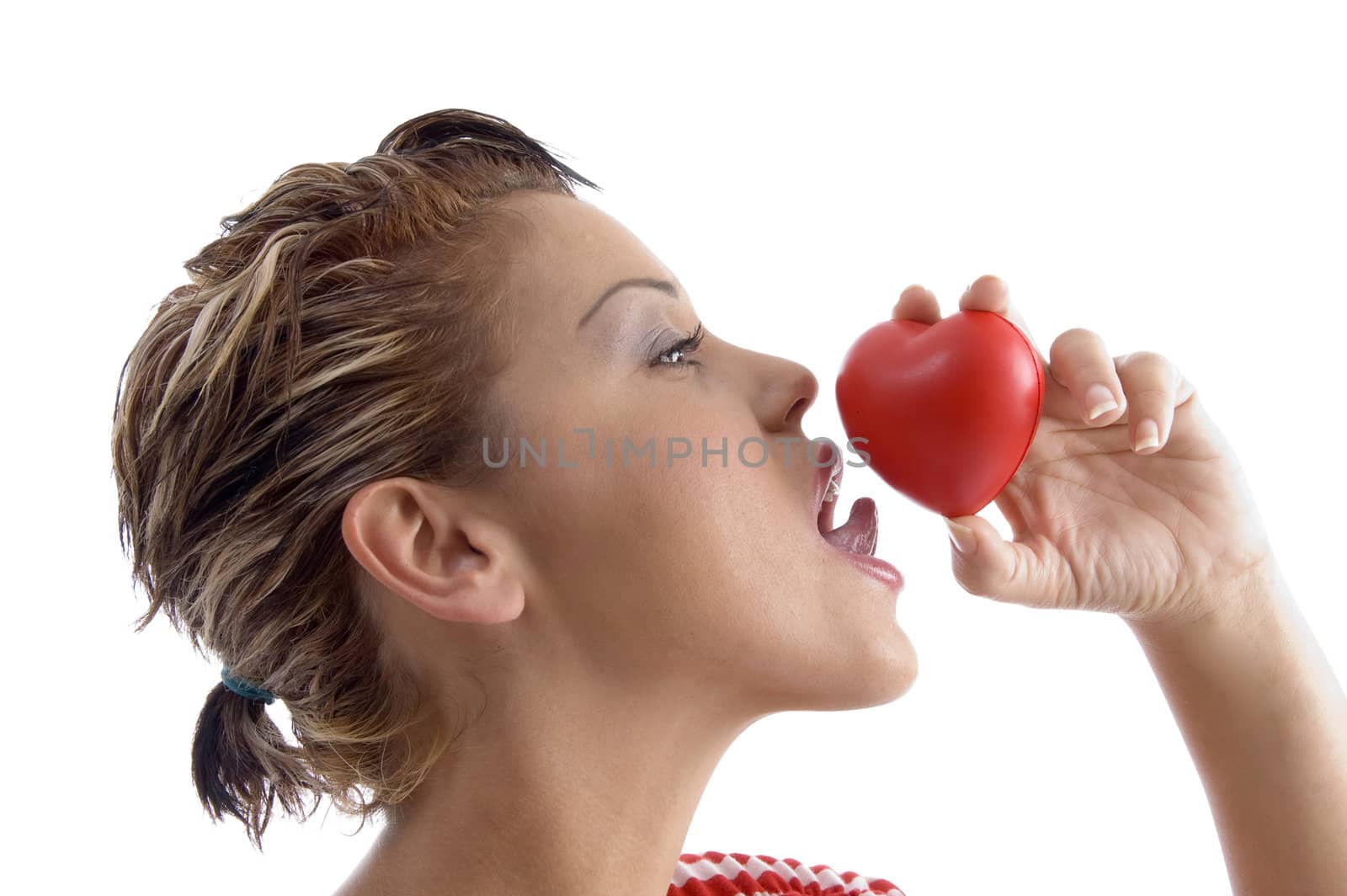 side face of woman licking a heart by imagerymajestic