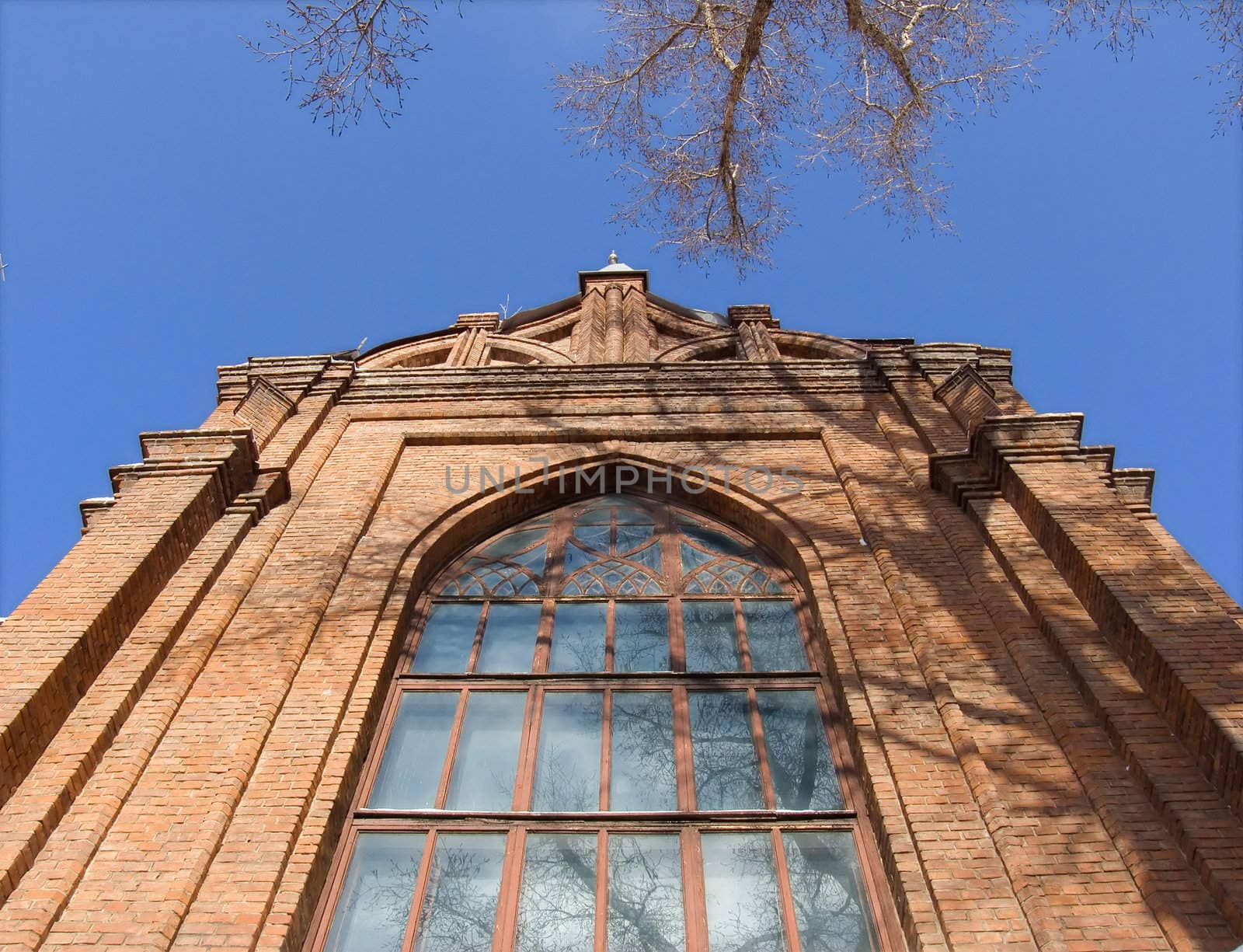 Gothic cathedral with a bell tower against the blue sky.