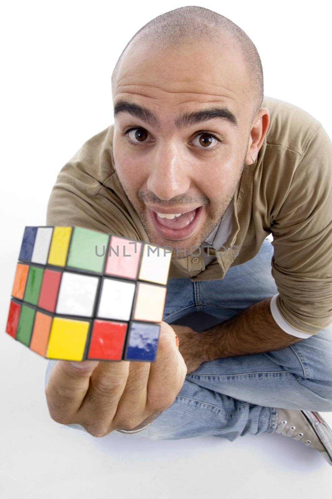 young guy showing his puzzle cube on an isolated white background