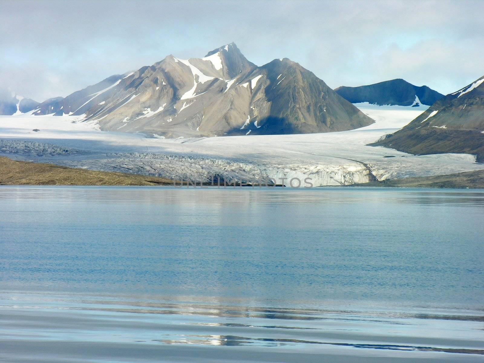 Artic glacier by the sea in Svalbard , Norway