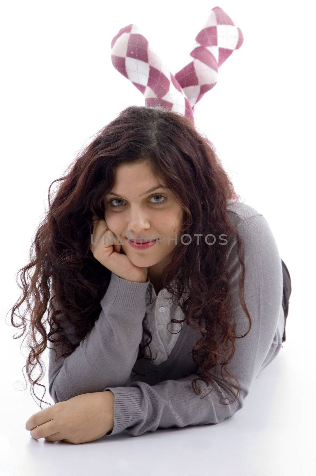 female looking at camera in stylish lying pose on an isolated white background