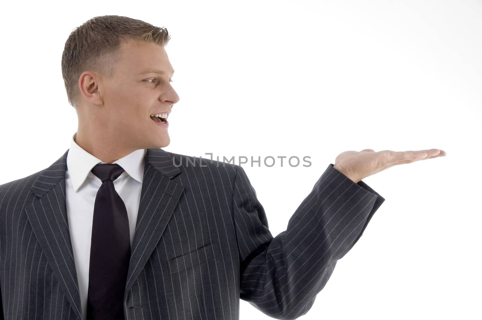 smiling adult businessman looking his palm on an isolated background