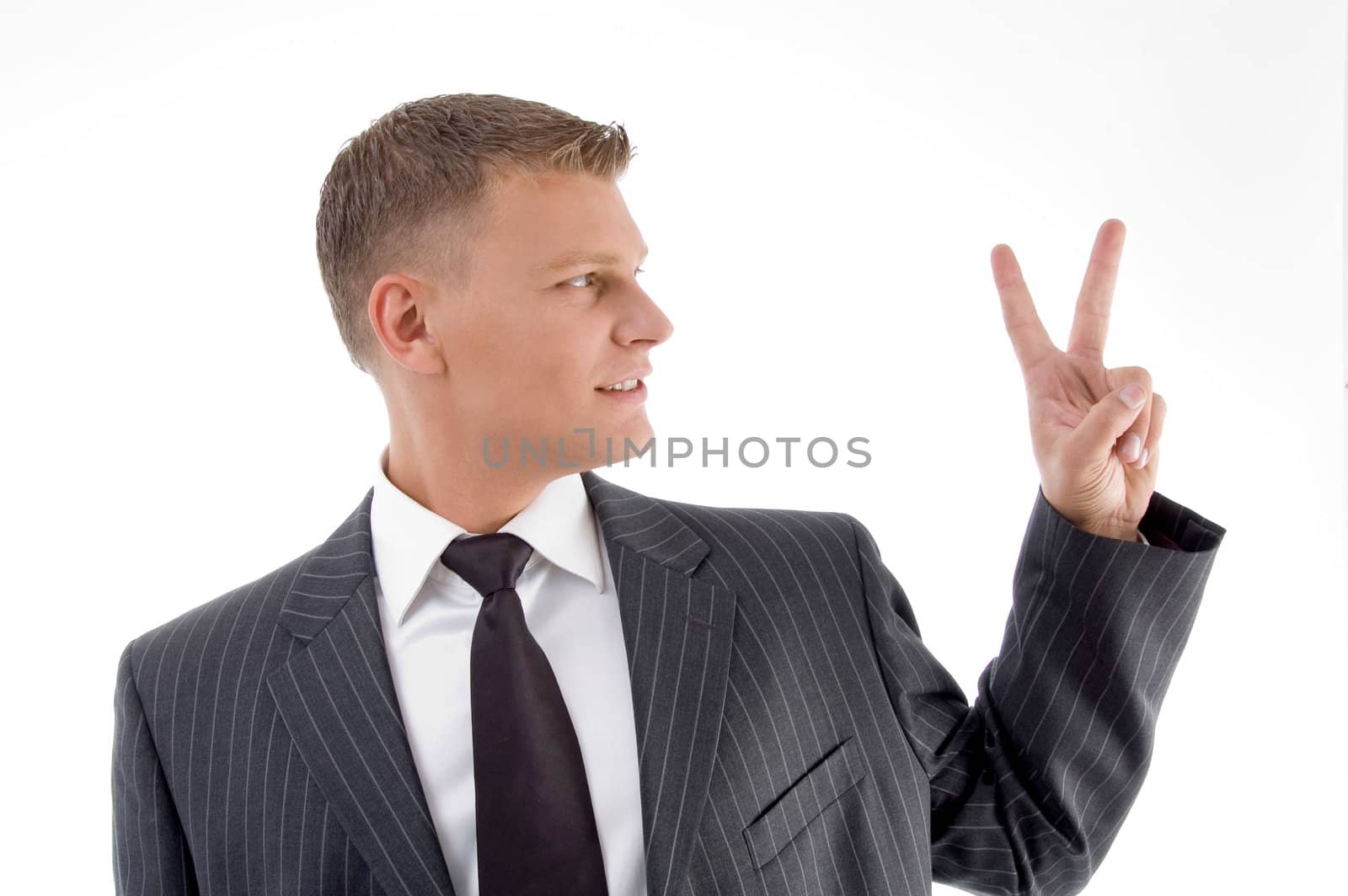 portrait of businessman showing peace sign by imagerymajestic