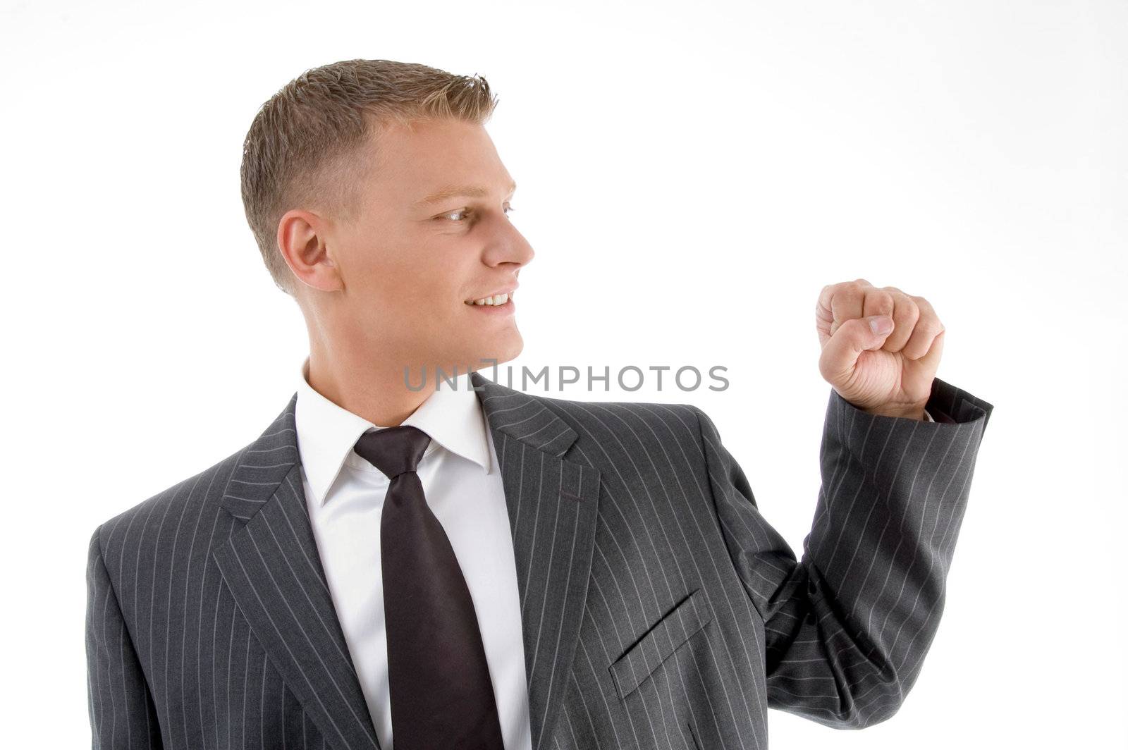 smiling businessman looking his fist on an isolated white background