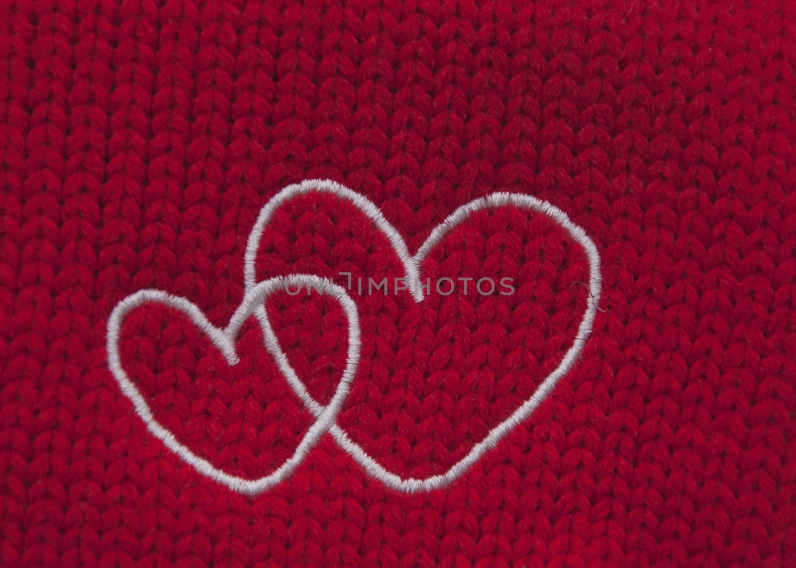 The hearts embroidered with white threads on red background