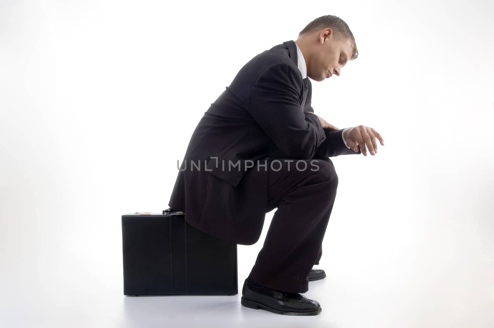 young accountant having a look at his watch on an isolated white background