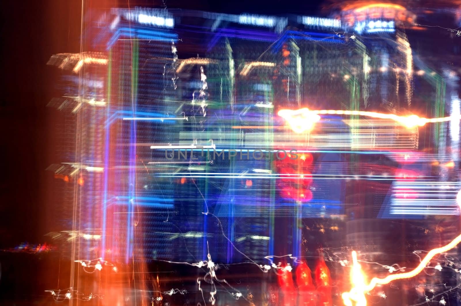 Shanghai city by night, blured neons and skyscrapers with different colorful reflections.