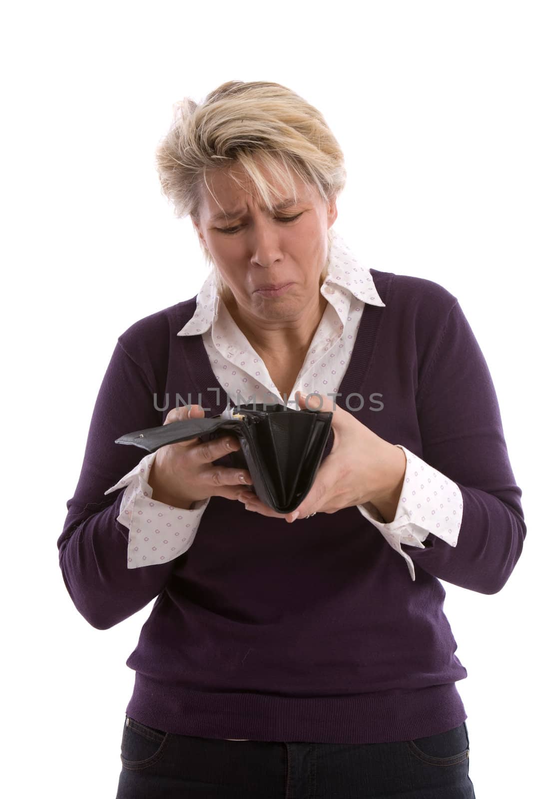 Mature woman looking into her wallet with a troublesome look