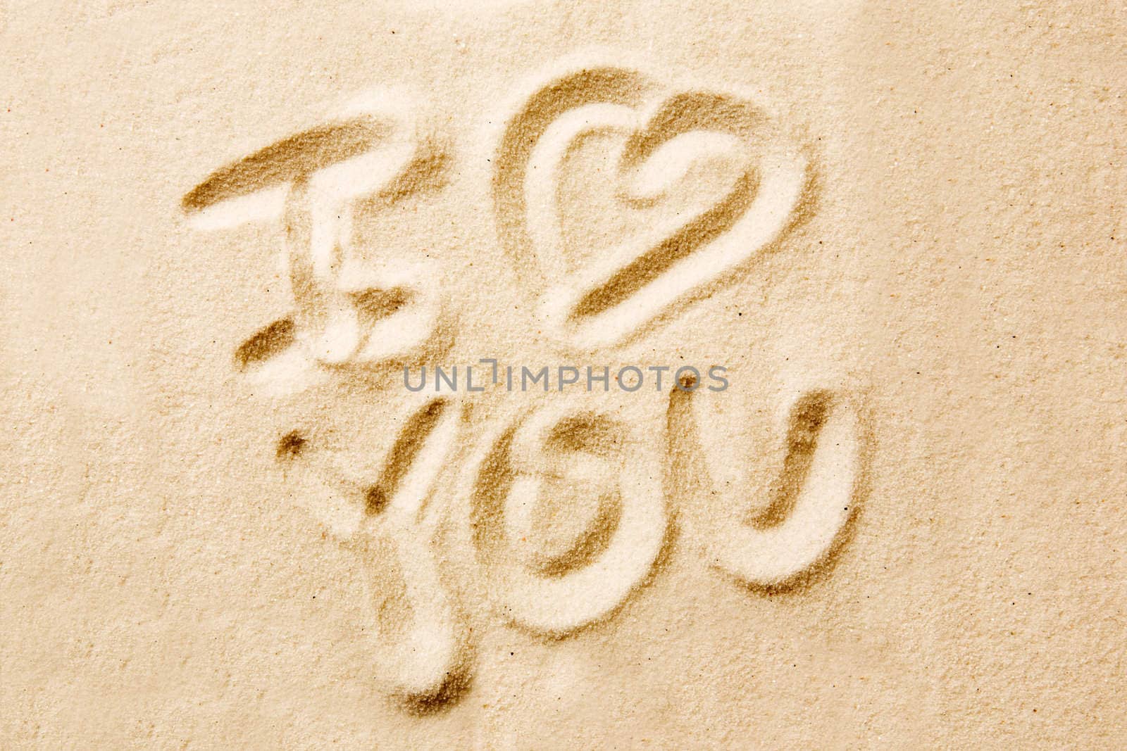 I love you message written in golden sand