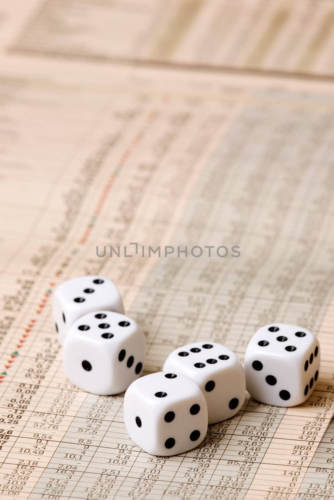 Dice sitting on a stock market chart