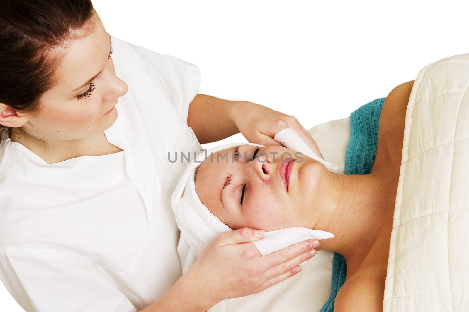 Lotion being massaged into face a beauty spa.