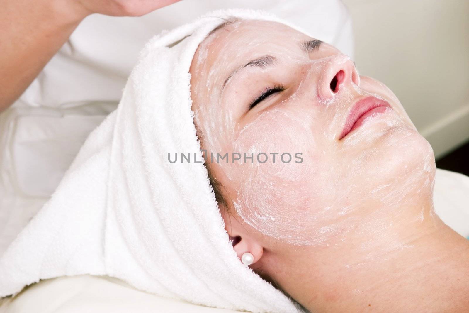 Relaxing during a facial treatment at a beauty spa.