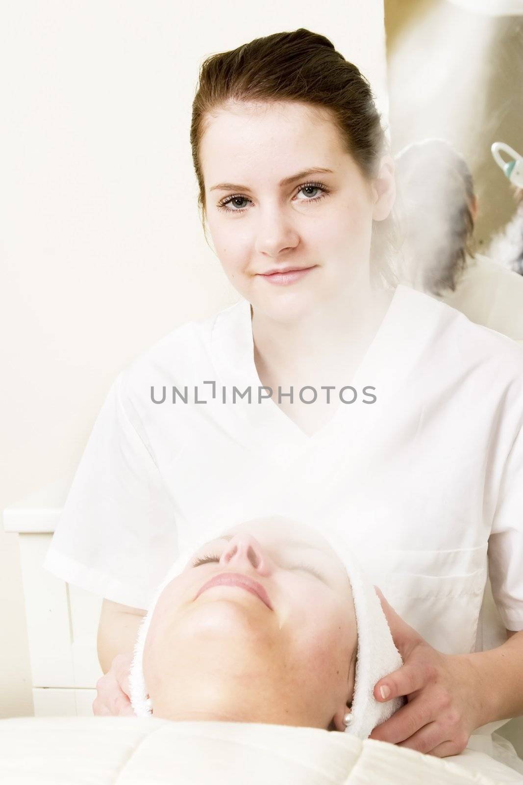 Steam treatment during a facial at a beauty spa.