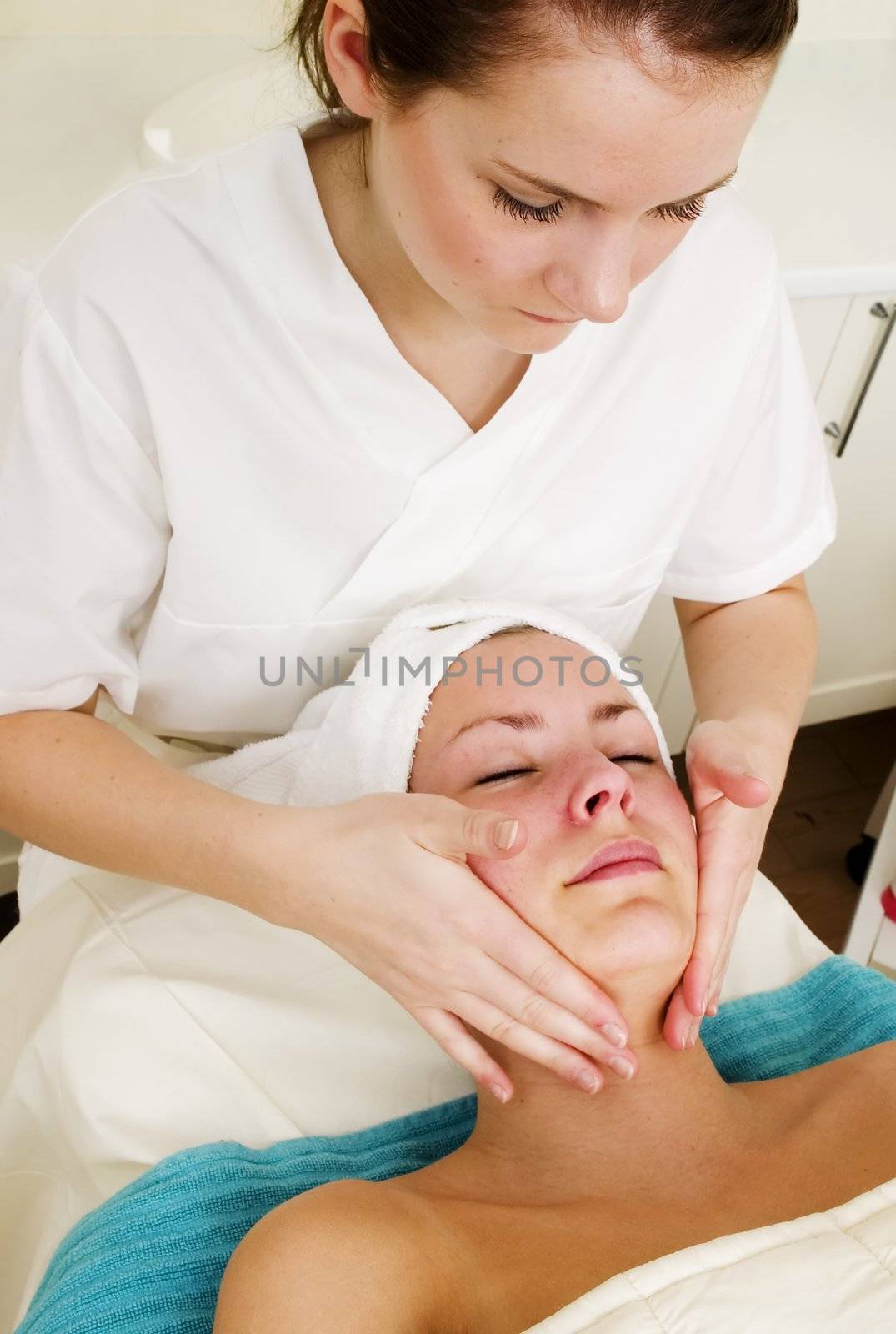 A face massage during a facial at a beauty spa.