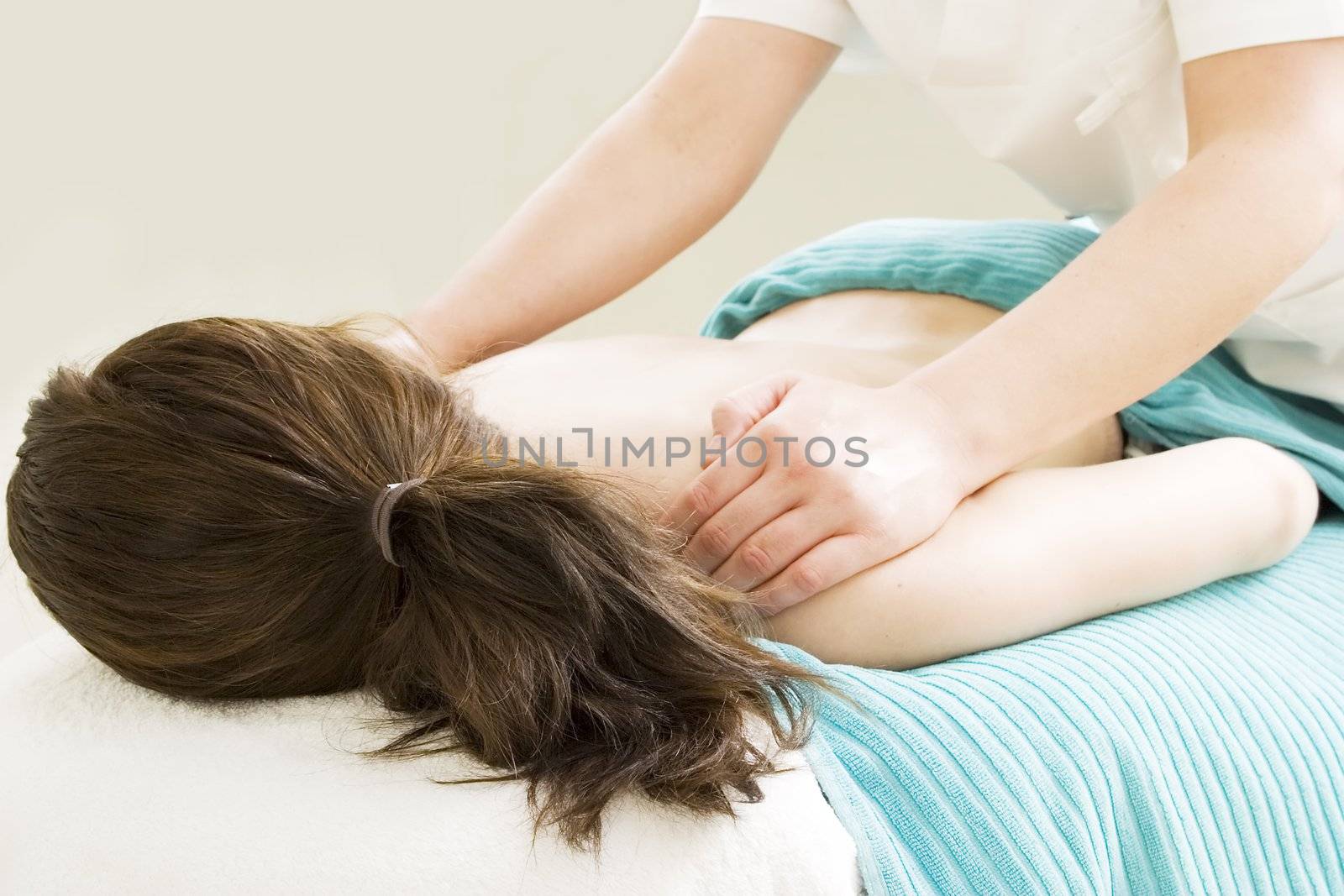 Shoulder massage detail at a beauty spa.