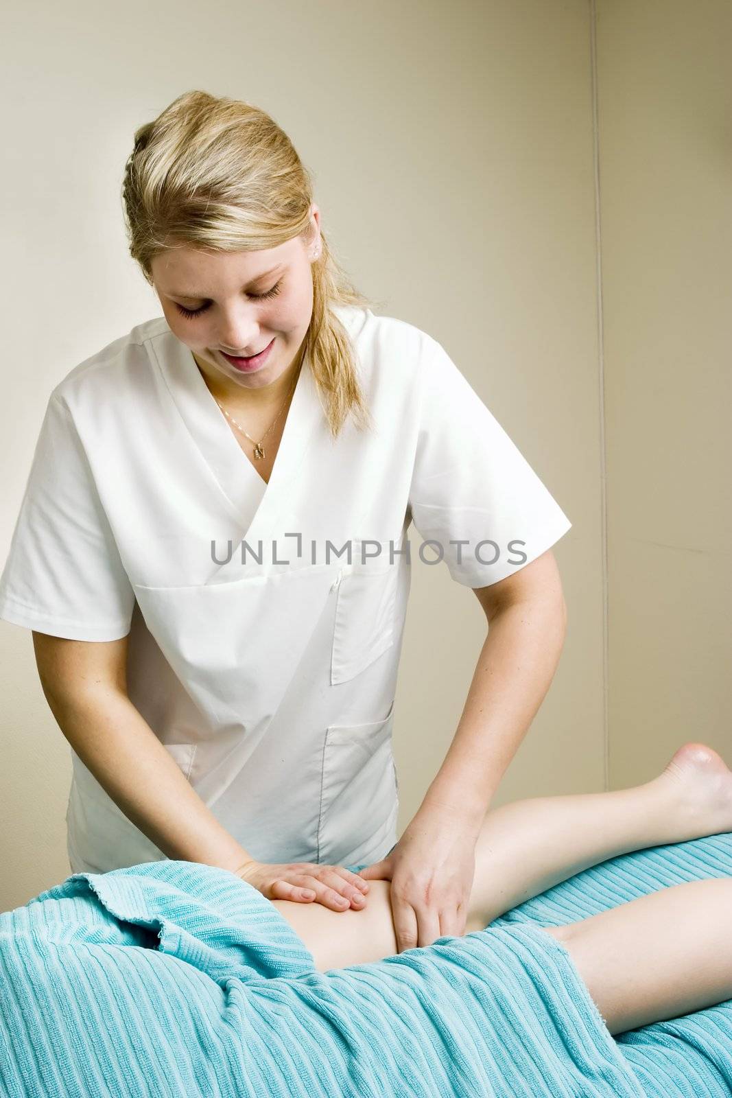 A detail image of a female leg being massaged.