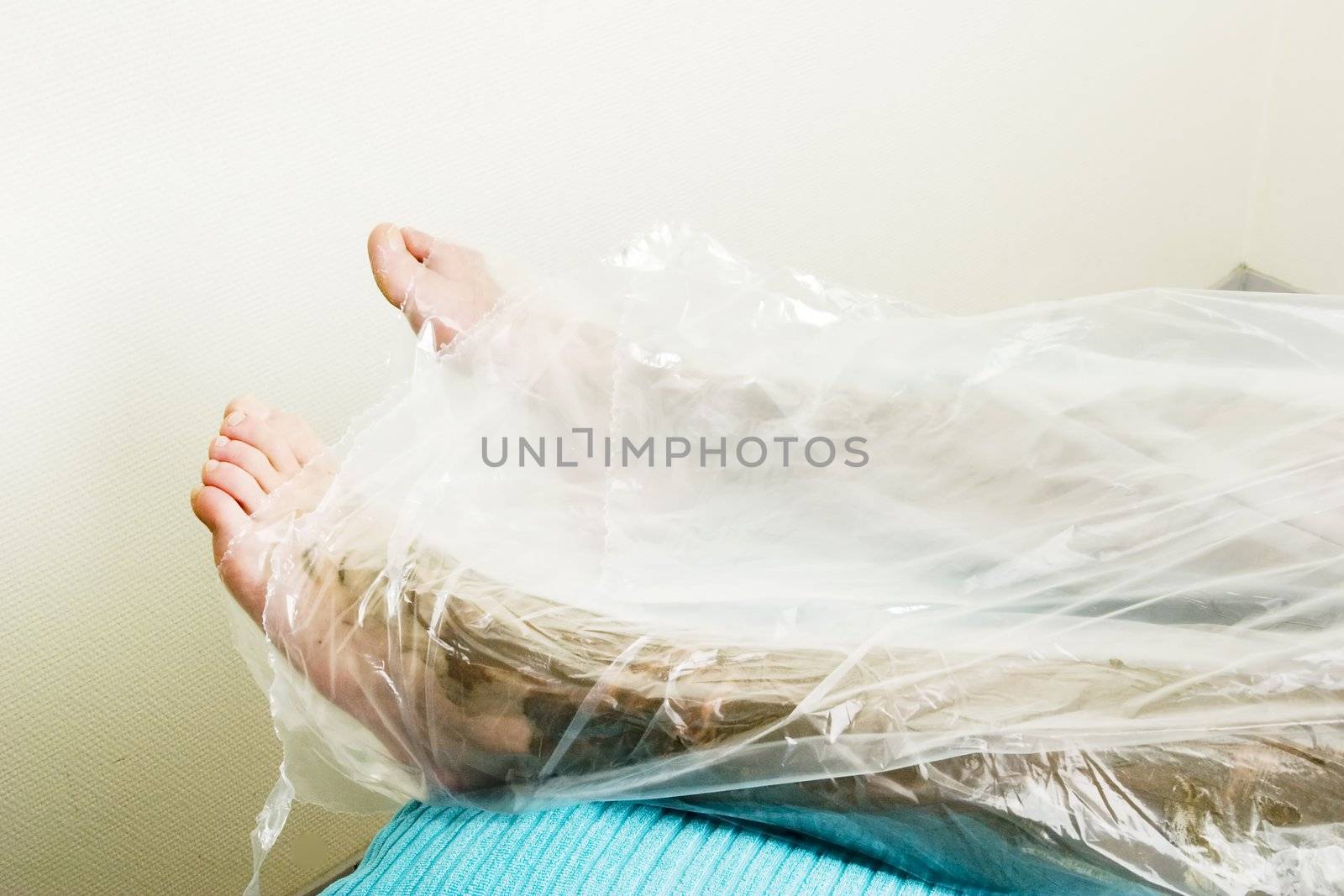 A detail image of the feet wrapped in during a sea mud full body wrap at a luxury spa.