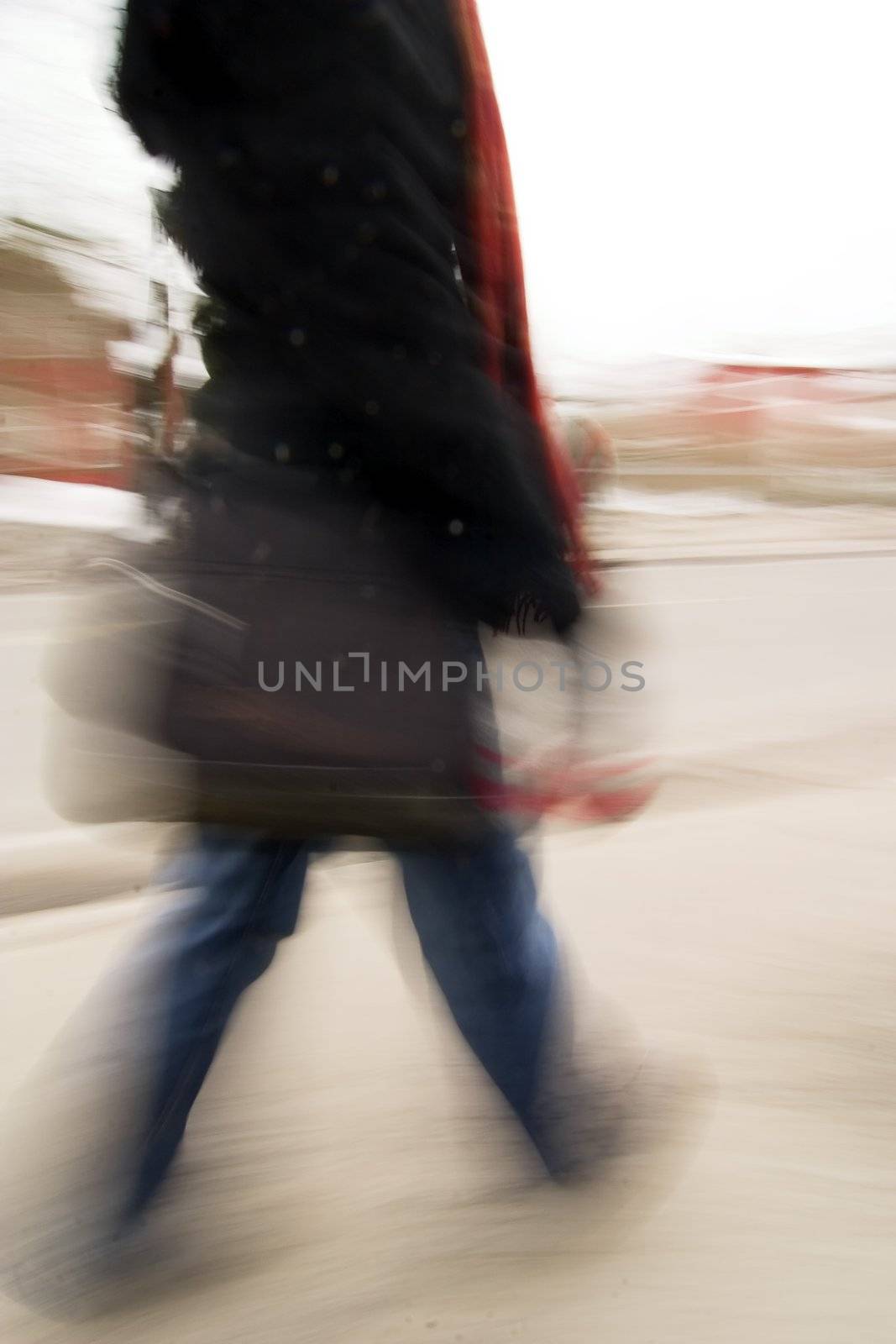A motion blur abstract of a person walking in a hurry, a late rushing concept image.