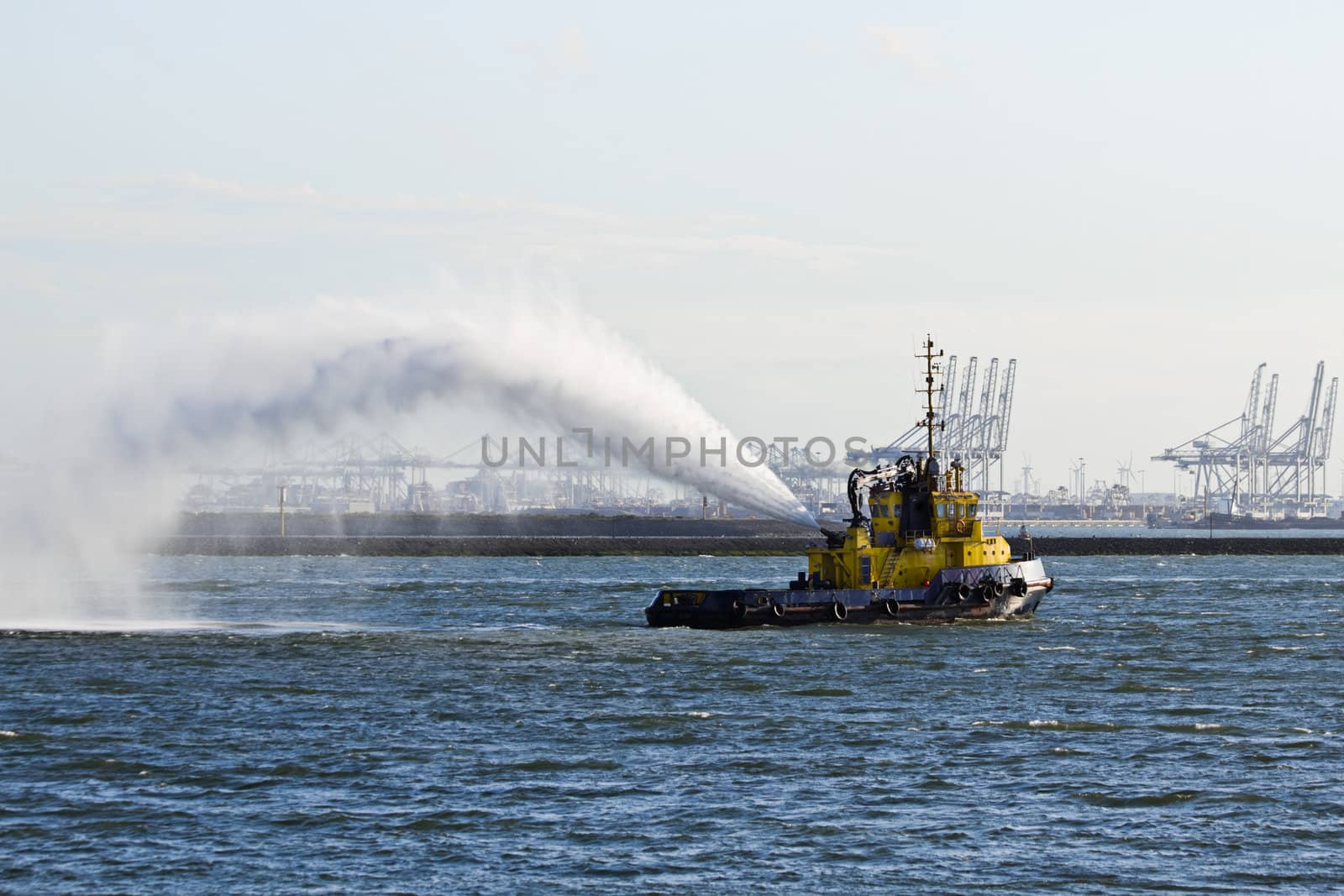 Fire fighting boat demonstrates spraying jets of water on the river