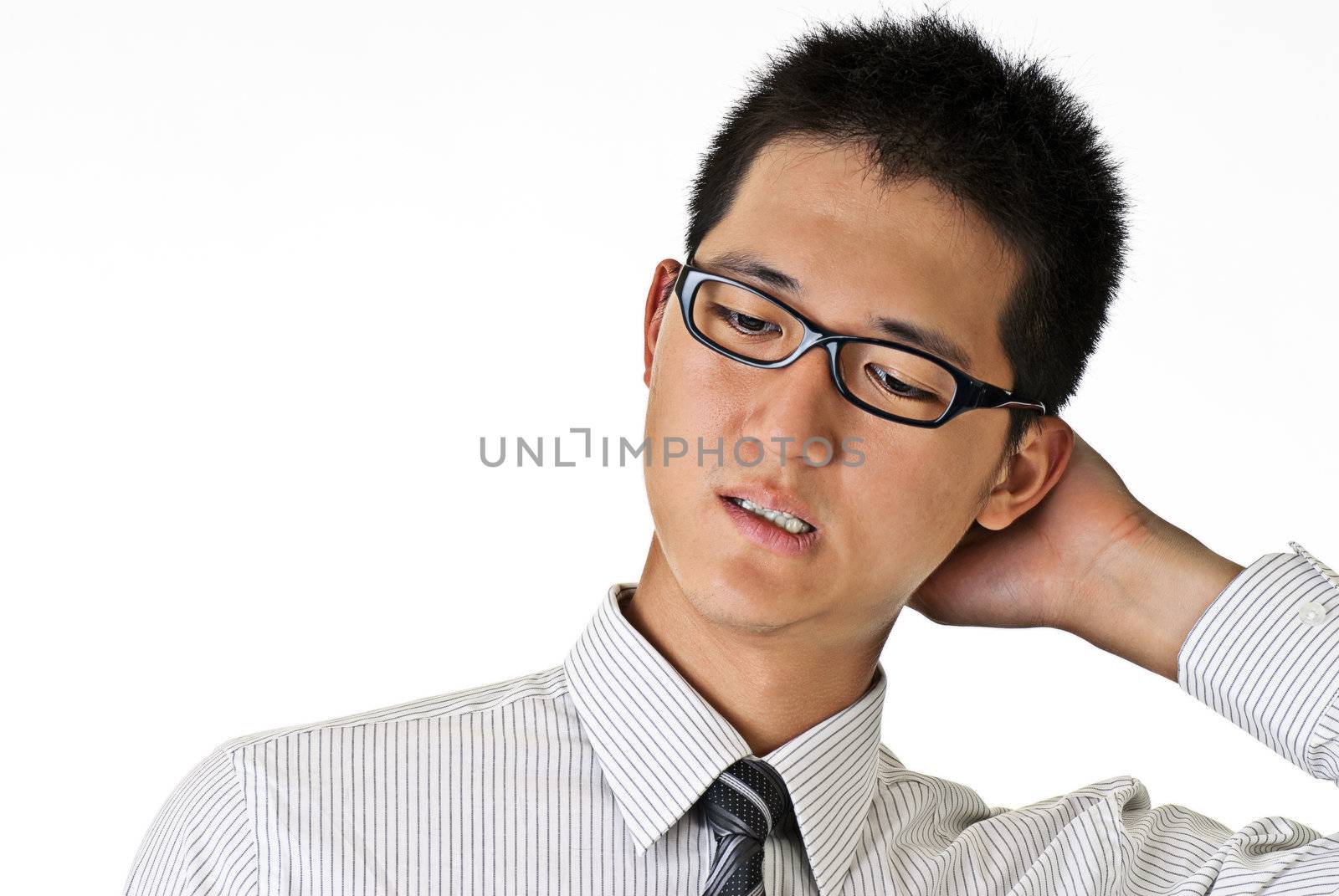 Closeup portrait of shy young business man against white with copyspace.