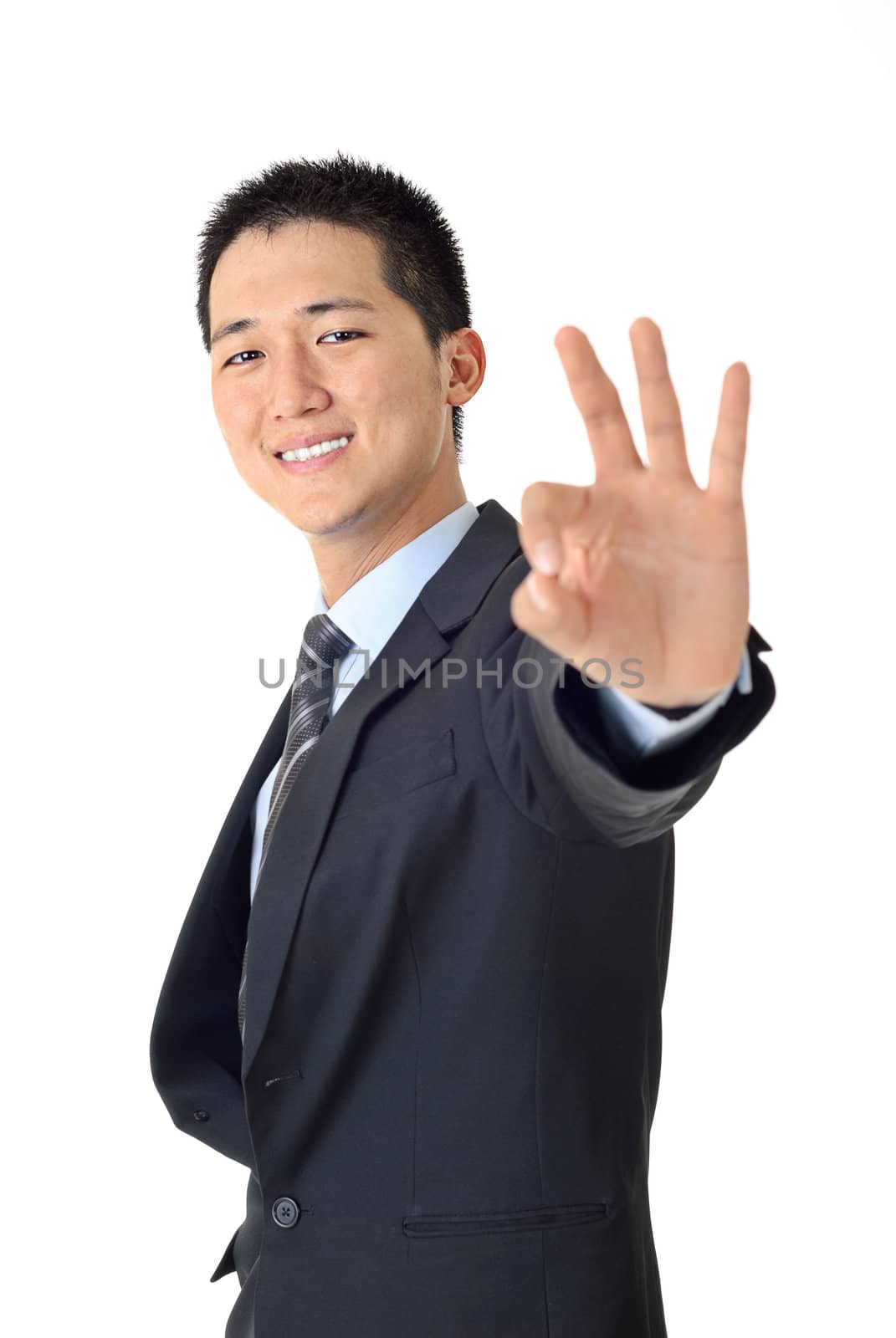 Closeup of a smiling young businessman gesturing an excellent job against white.