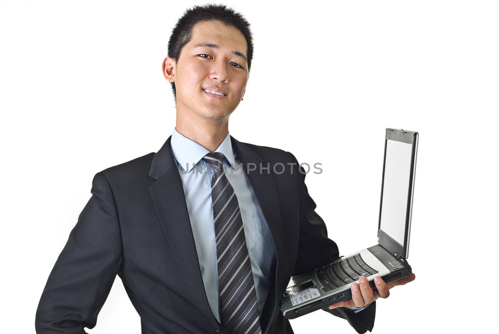 Happy business man holding laptop against white.