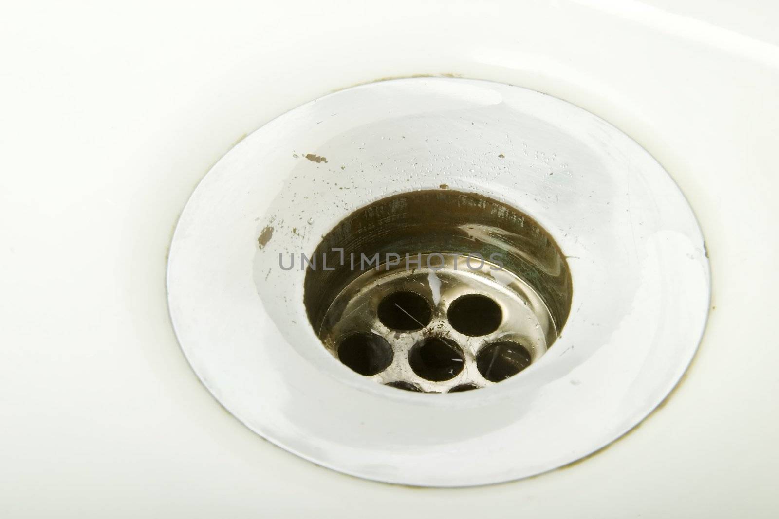A drain on a retro porcelain sink.