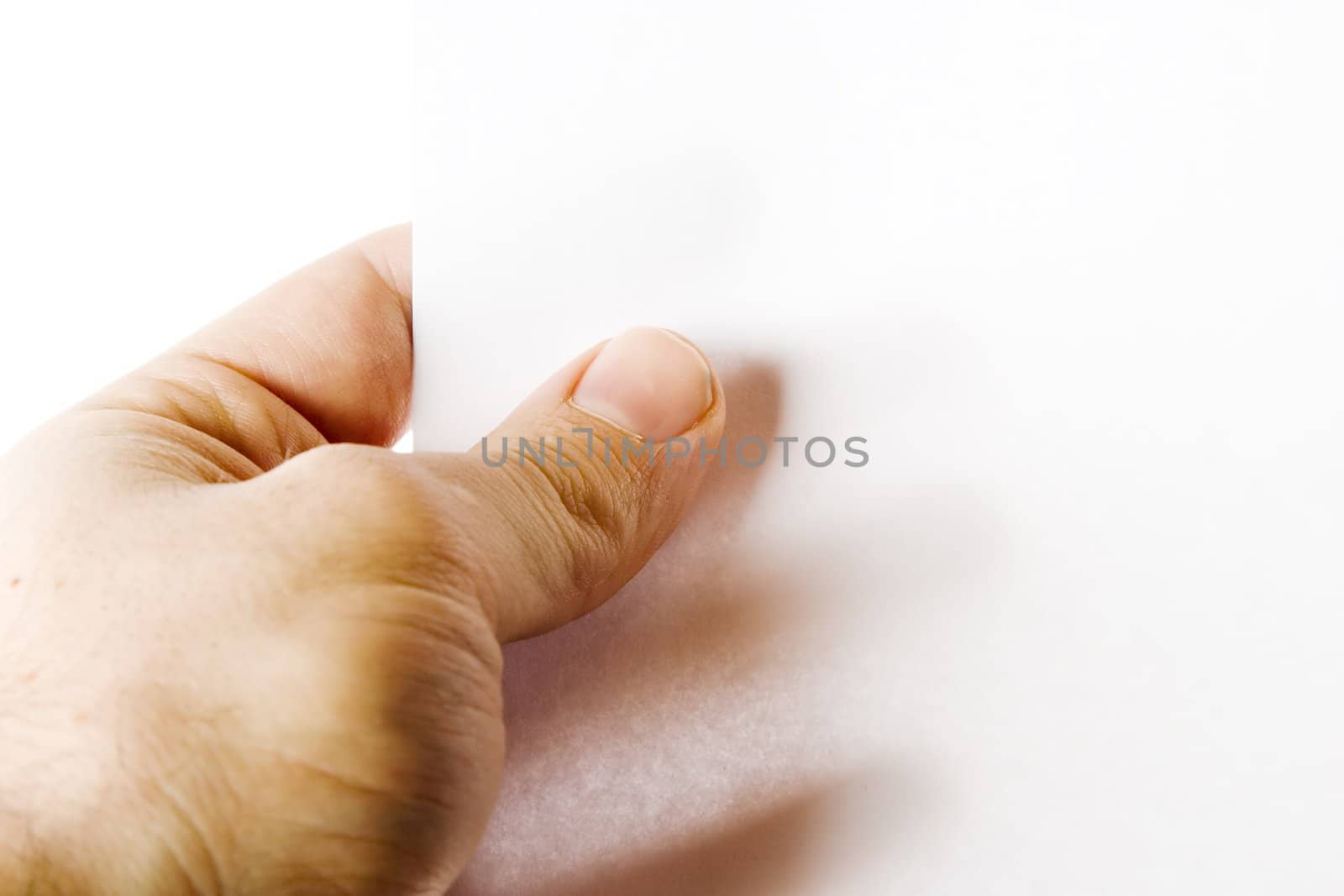 A males hand holding up a white paper with nothing on it (put on your own text or image or leave as blank).  Isolated on white with clipping path.