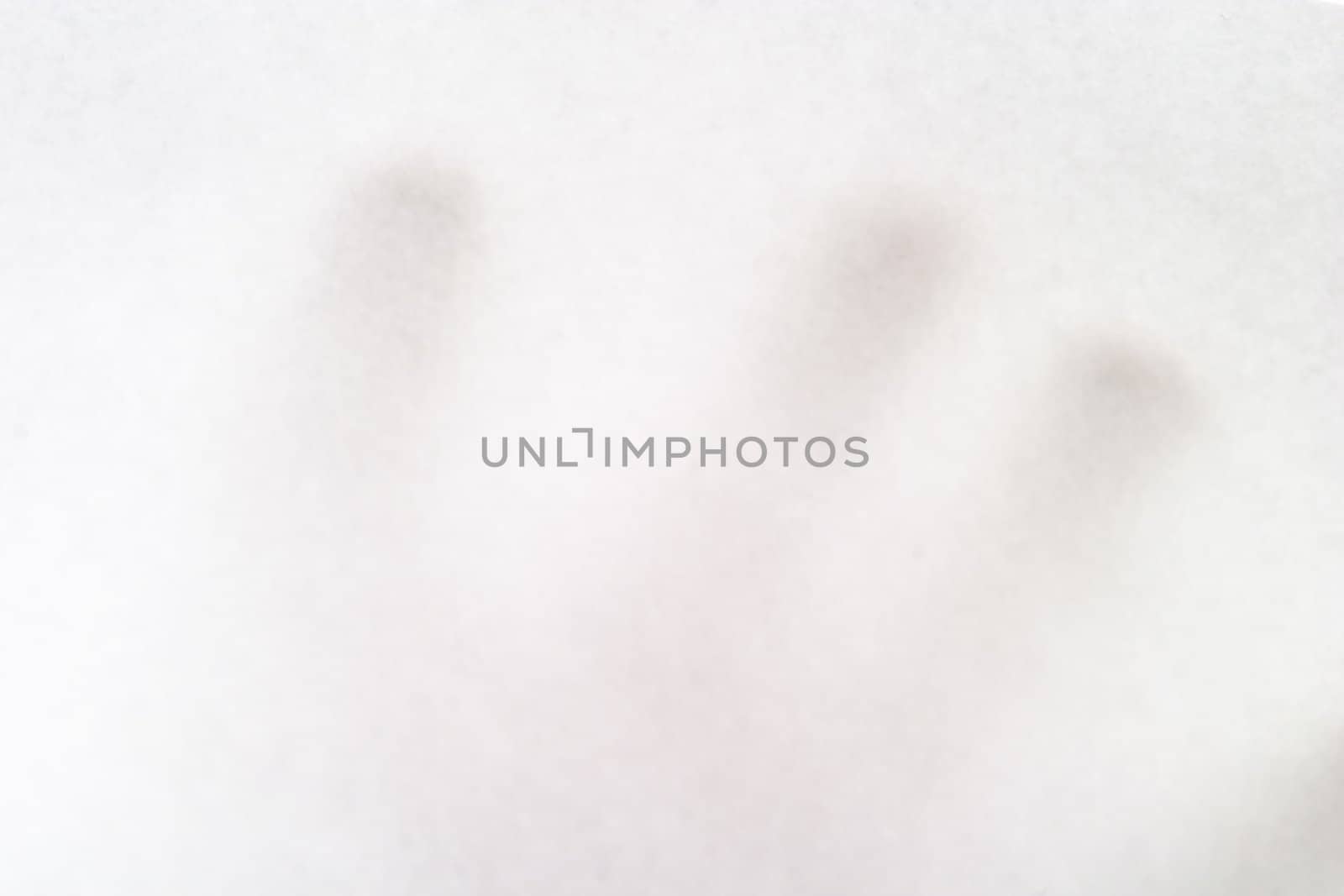 A males hand holding up a white paper with nothing on it, texture background image.  The hand is bairly visible behind the opaque paper.