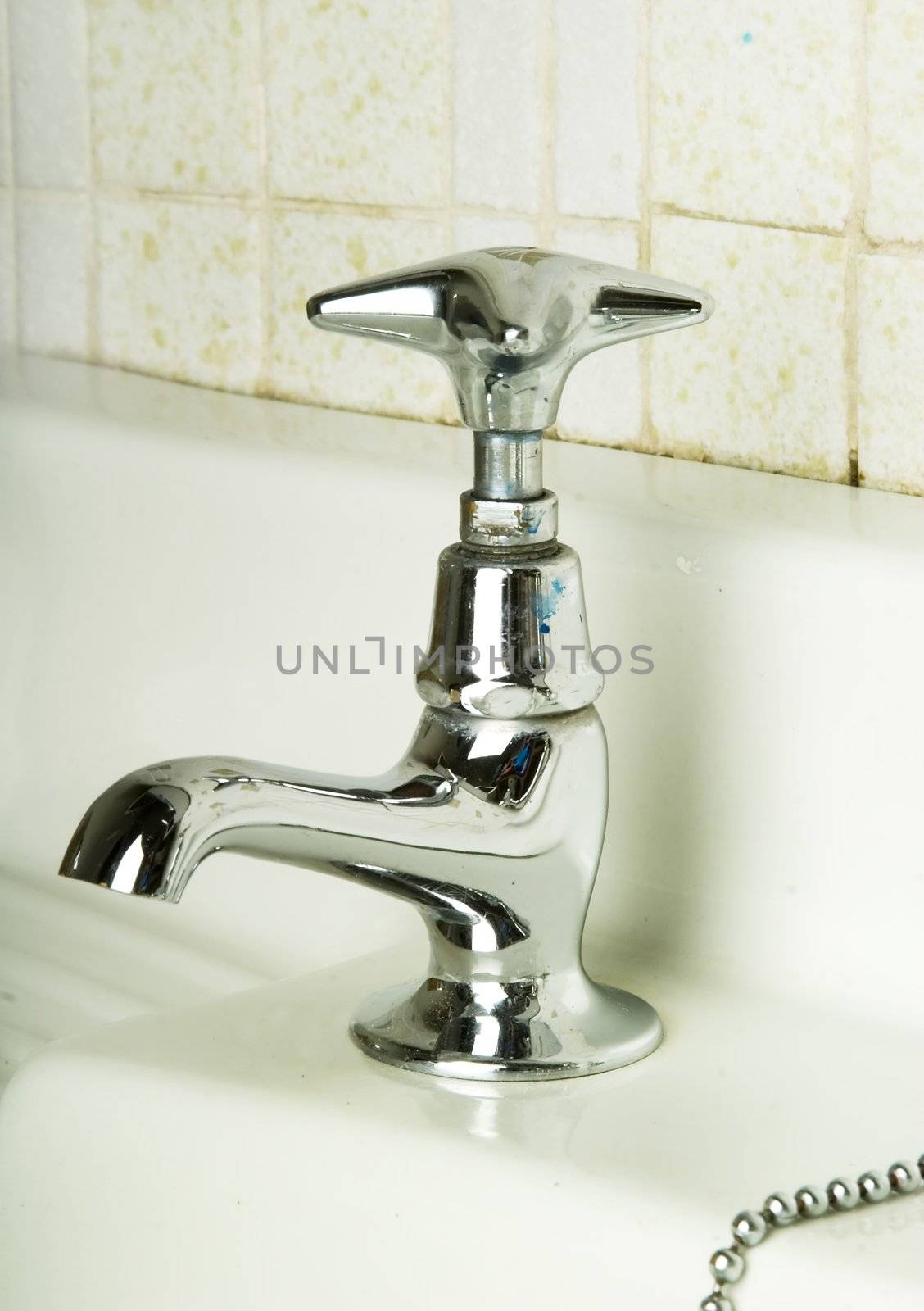 A retro bathroom sink tap. (vertical image)