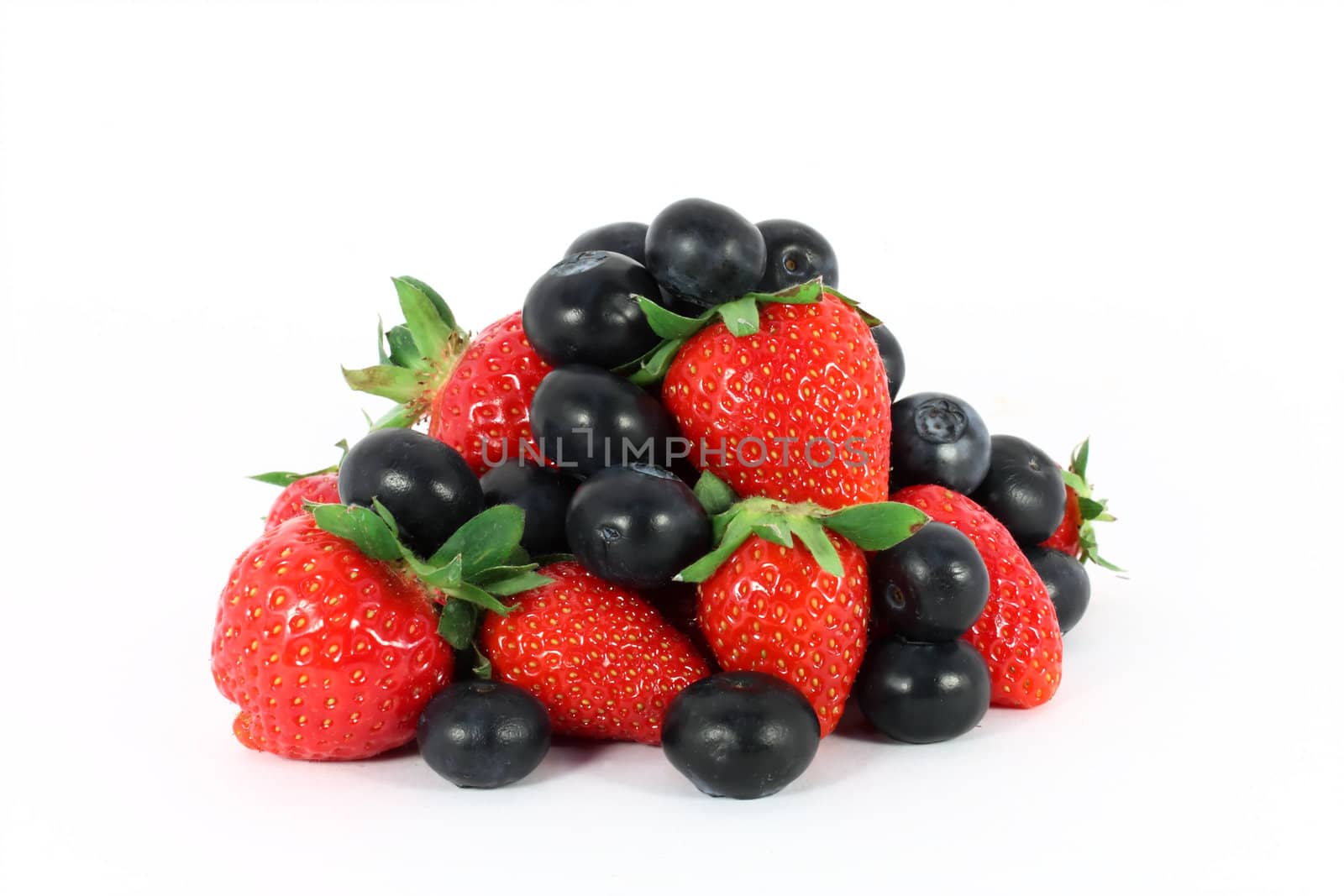 Heap of sweet strawberries and blueberries isolated on white