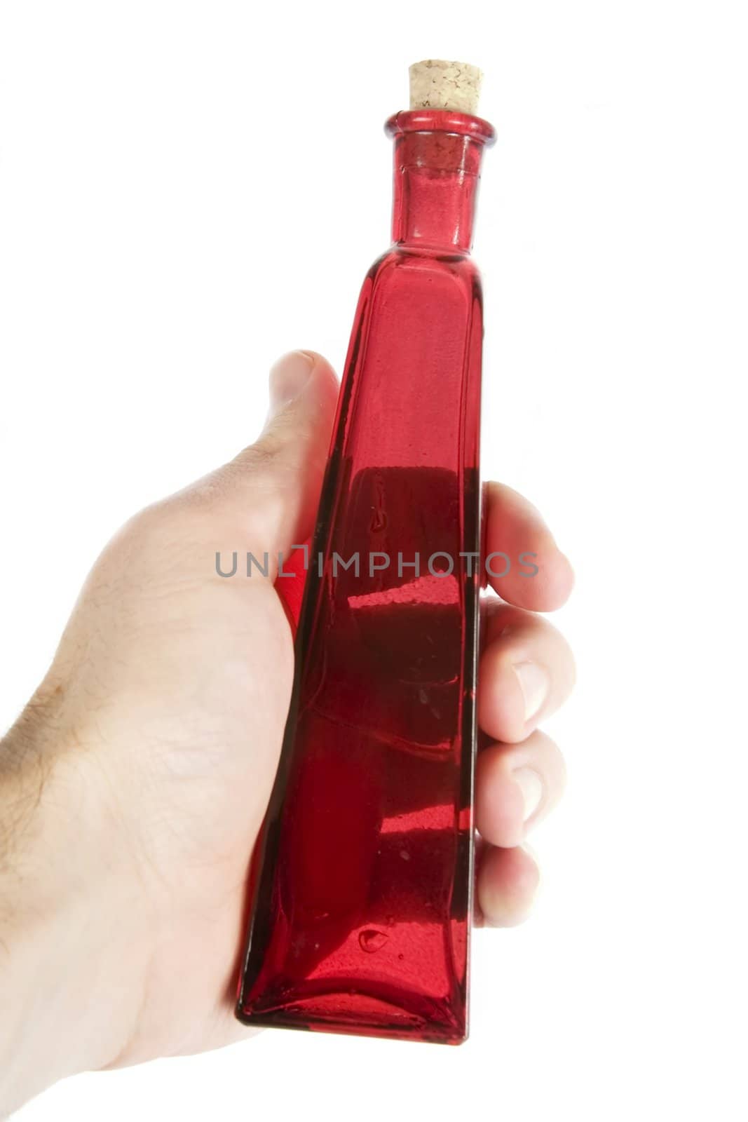 A male hand holding red glass bottle isolated on white with clipping path. Love potion number nine.