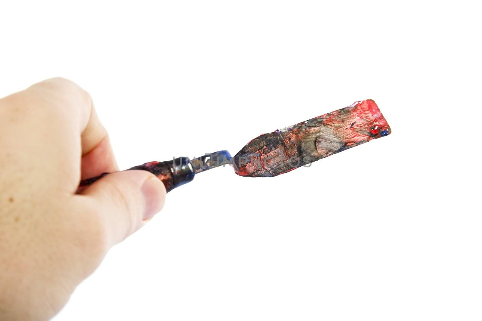 A pallet knife held in a hand.  Isolated on white with clipping path.