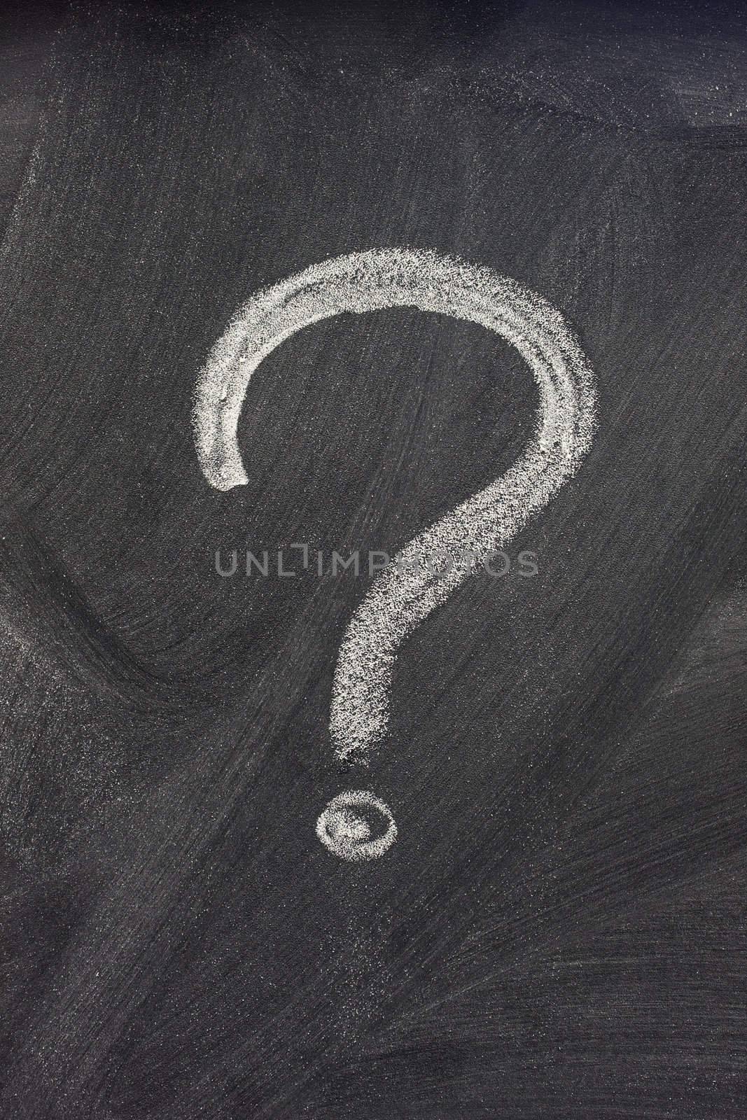 question mark handwritten with a white chalk on on a blackboard