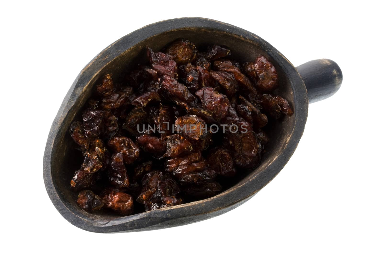 dried cranberries on a primitive, wooden, dark pinted, scoop, isolated with clipping path