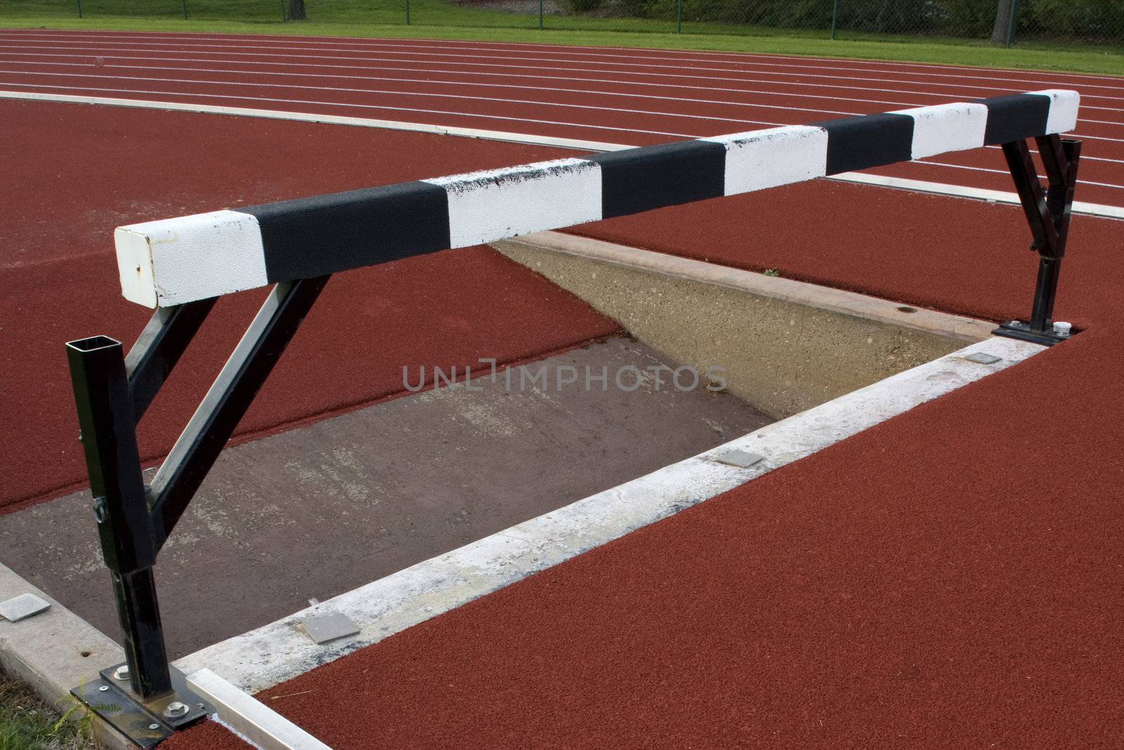 running tracks with steeplechase barrier and water jump by PixelsAway